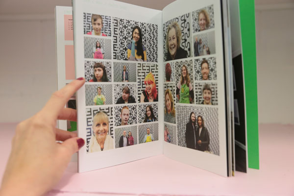Open book showing lots of portrait photos.