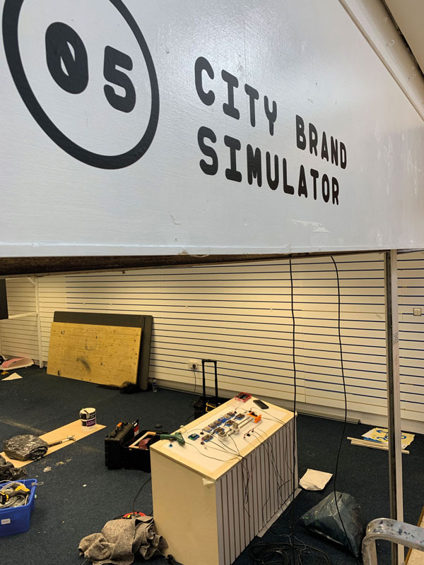 Technical equipment sits under the sign City Brand Simulator.