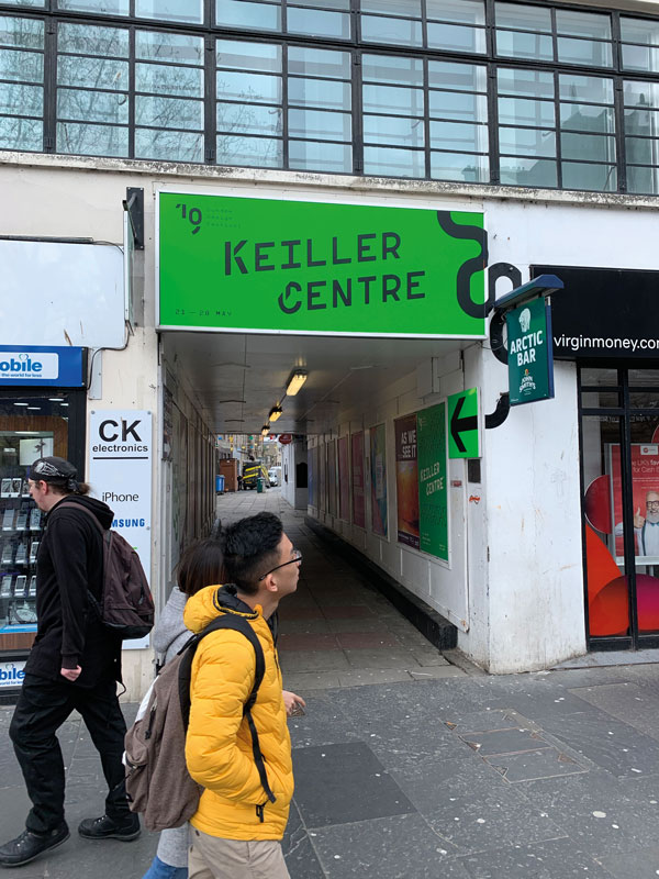 Entrance to the Keiller Centre with luminous green backing and black branding for the 2019 Dundee Design Festival.