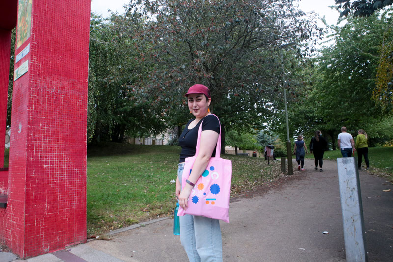 At the entrance to the Hilltown Park person shows off tote bag.