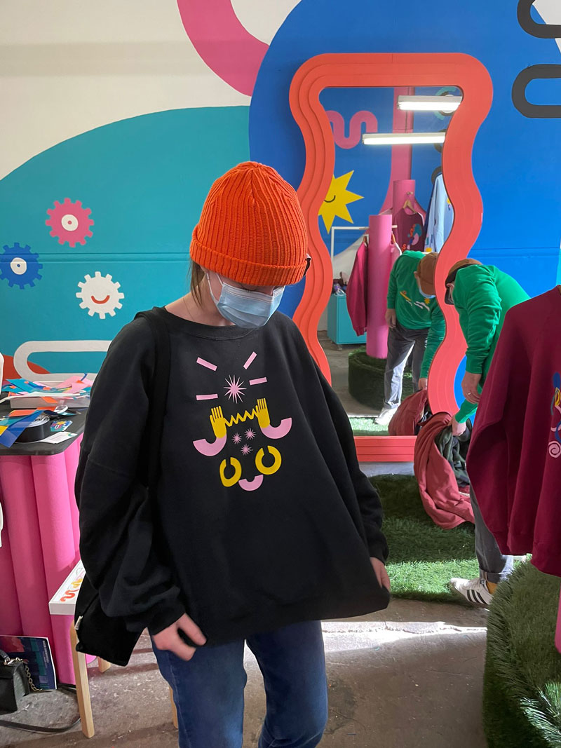 Woman admires her sweatshirt creation.